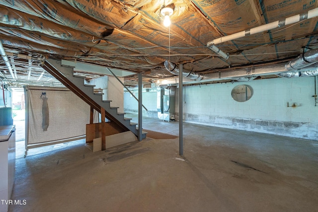 unfinished below grade area with heating unit and stairs