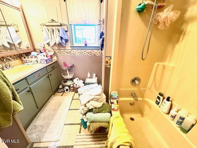 bathroom with tile patterned floors, shower / washtub combination, and vanity