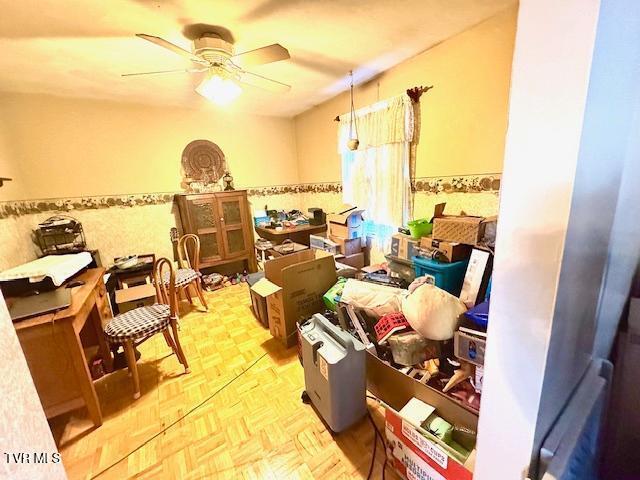 interior space featuring ceiling fan and light parquet floors