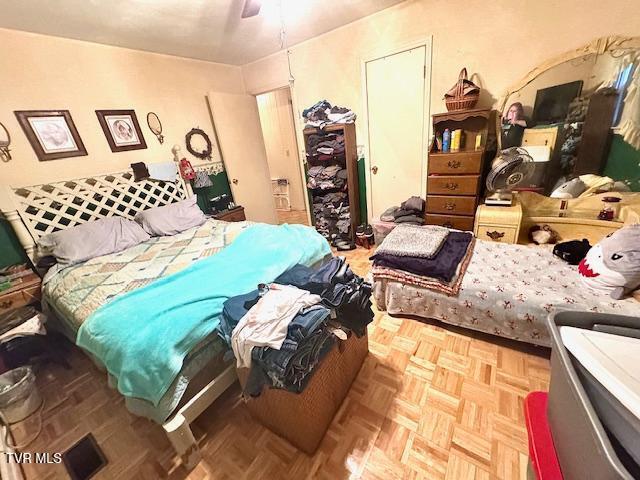 bedroom featuring ceiling fan and light parquet floors