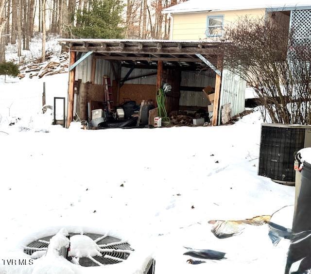 yard layered in snow featuring cooling unit