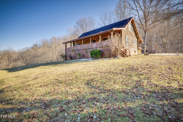 view of home's exterior featuring covered porch and a yard