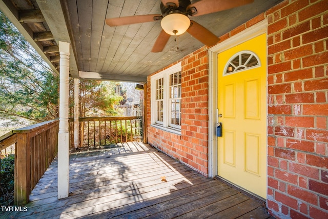 wooden deck featuring a porch and ceiling fan