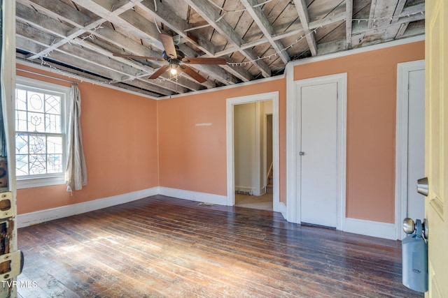 basement featuring ceiling fan and dark wood-type flooring