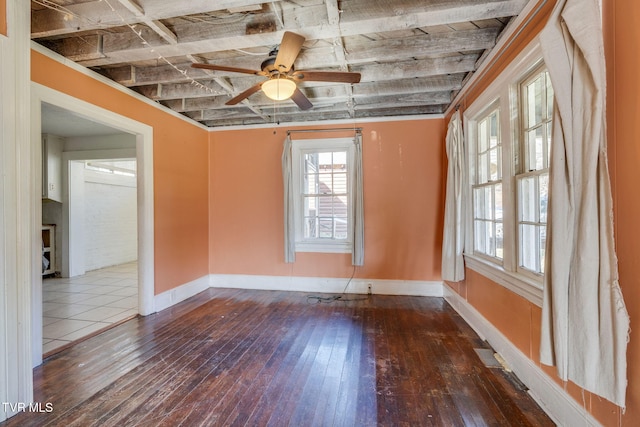 unfurnished room with ceiling fan and dark wood-type flooring