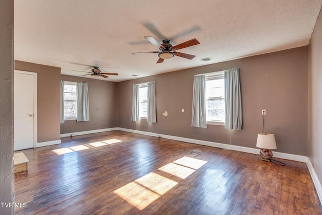 empty room featuring a textured ceiling, dark hardwood / wood-style flooring, and ceiling fan