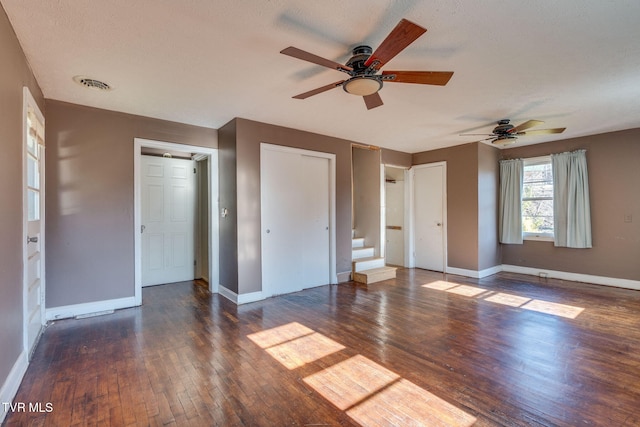 unfurnished bedroom featuring dark hardwood / wood-style flooring and a textured ceiling