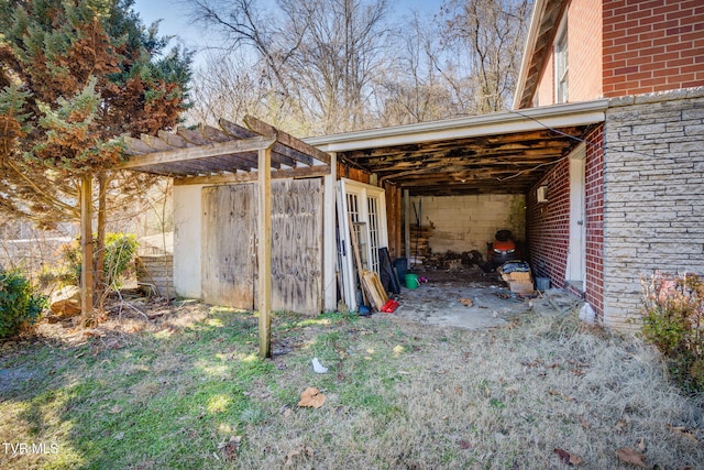 view of outdoor structure with a pergola