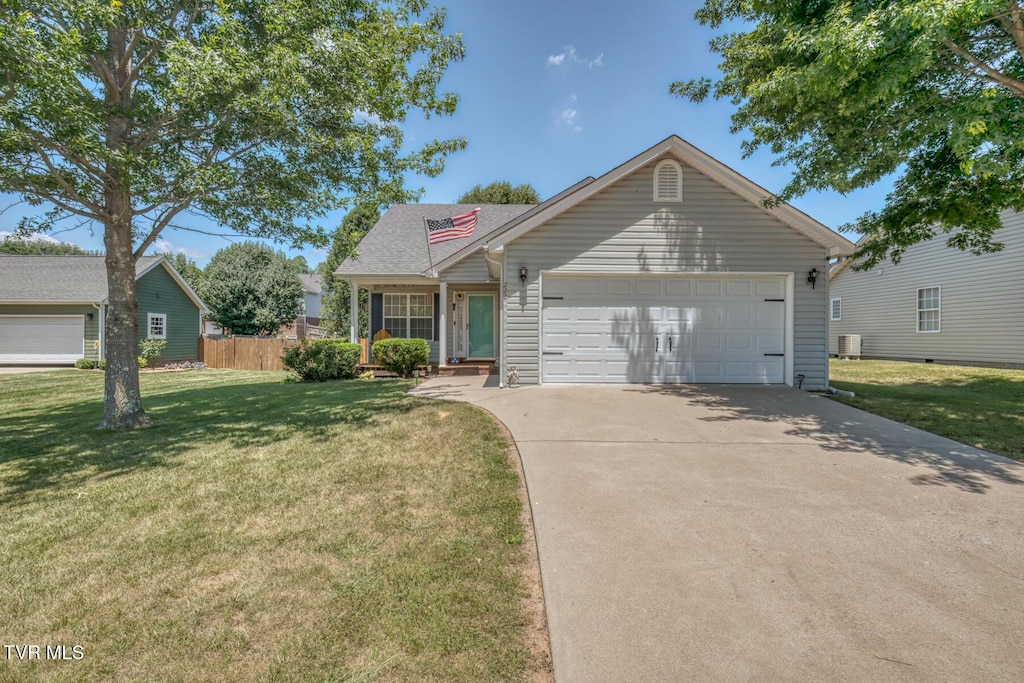 view of front of property with a garage, a front yard, and cooling unit