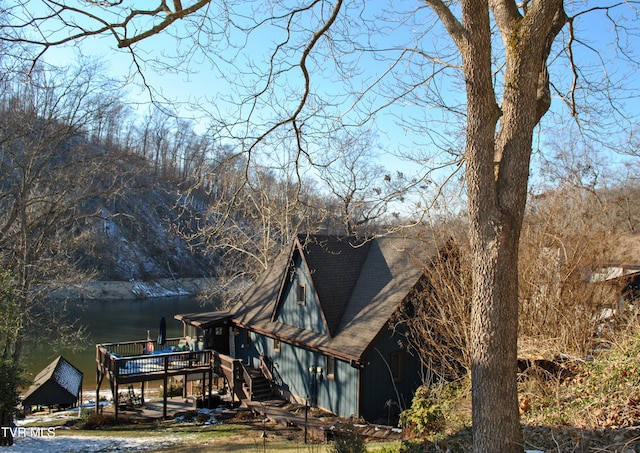 exterior space with a deck with water view