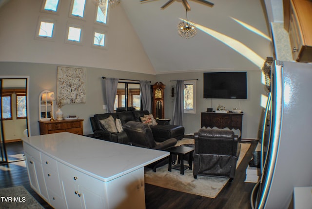 kitchen with a center island, white cabinetry, dark hardwood / wood-style floors, stainless steel fridge, and high vaulted ceiling