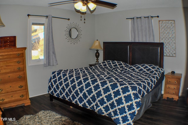 bedroom with dark wood-type flooring and ceiling fan