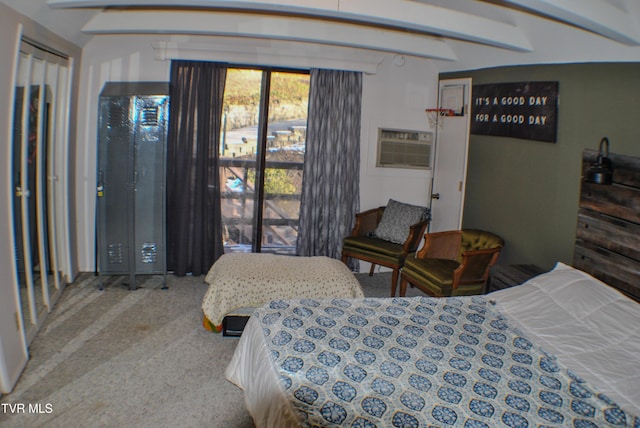 carpeted bedroom featuring a wall unit AC