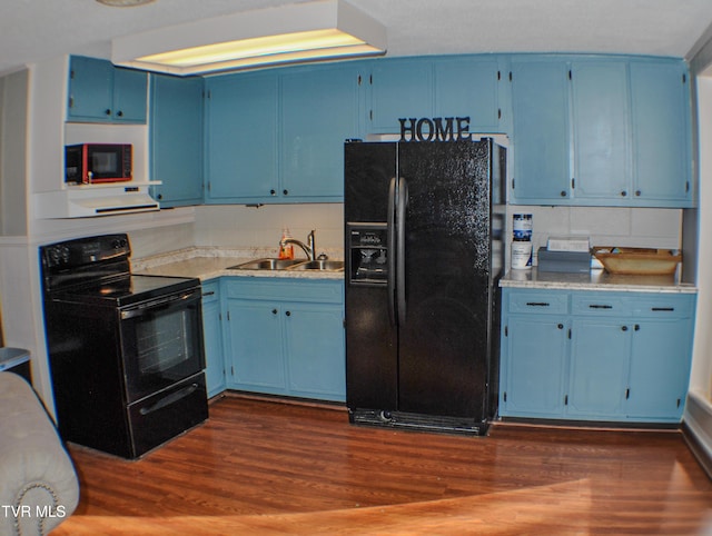 kitchen featuring dark wood-type flooring, sink, black appliances, and blue cabinets