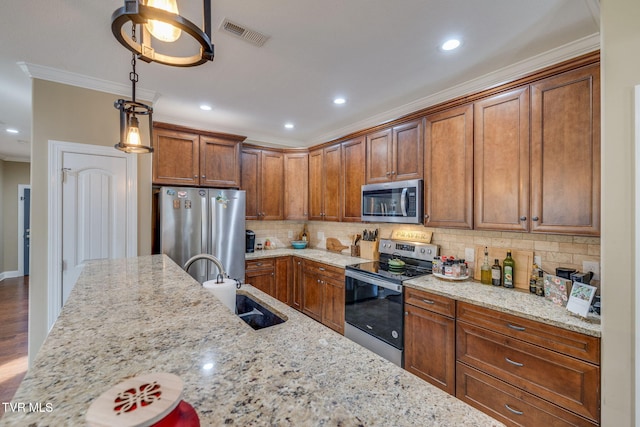 kitchen featuring light stone countertops, decorative light fixtures, and stainless steel appliances