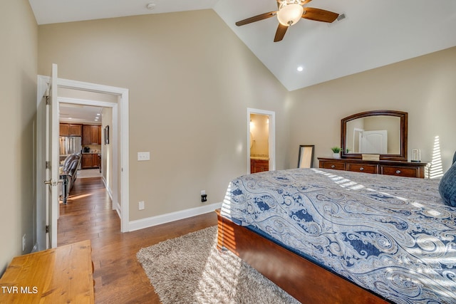 bedroom with wood-type flooring, high vaulted ceiling, connected bathroom, and ceiling fan