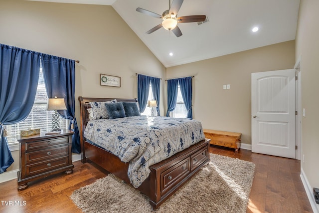 bedroom with ceiling fan, dark hardwood / wood-style flooring, and high vaulted ceiling