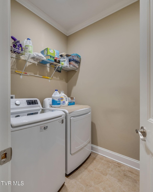 clothes washing area with ornamental molding and washing machine and clothes dryer