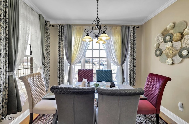 dining area with hardwood / wood-style floors, a notable chandelier, and ornamental molding