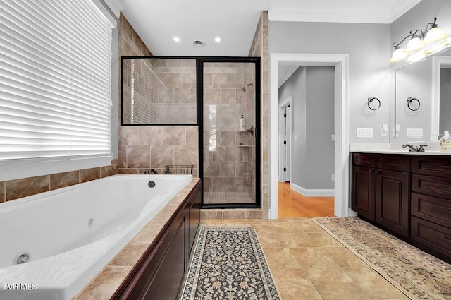 bathroom with tile patterned flooring, vanity, ornamental molding, and independent shower and bath