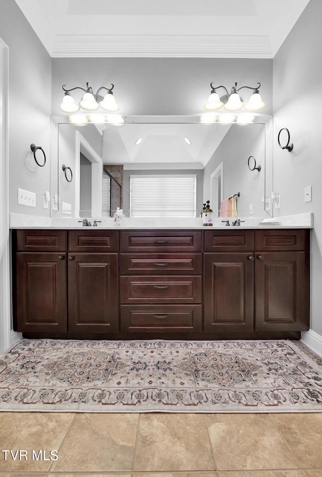 bathroom featuring crown molding, tile patterned flooring, and vanity