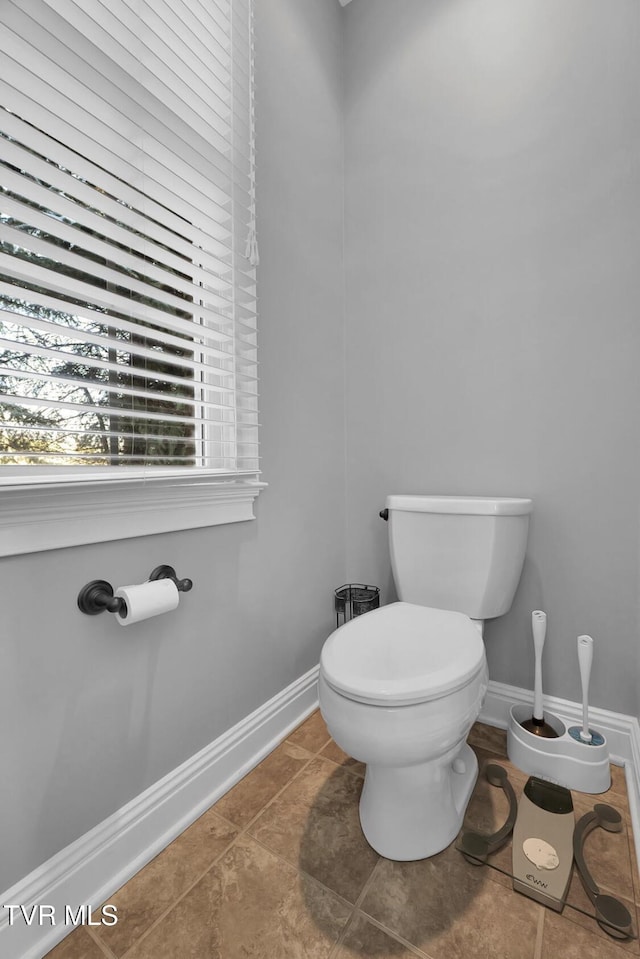 bathroom with tile patterned flooring and toilet