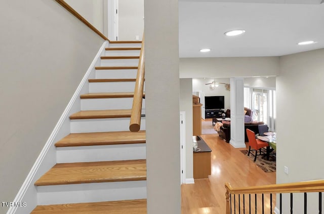 staircase with hardwood / wood-style floors