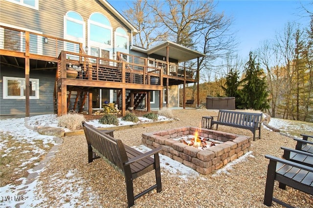 exterior space with a fire pit and a deck