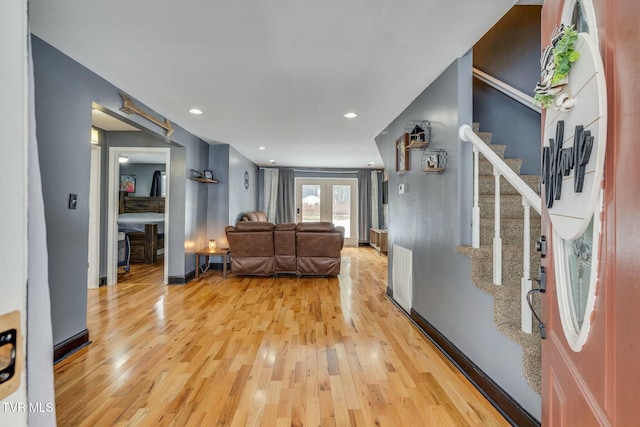 living room with wood-type flooring and french doors