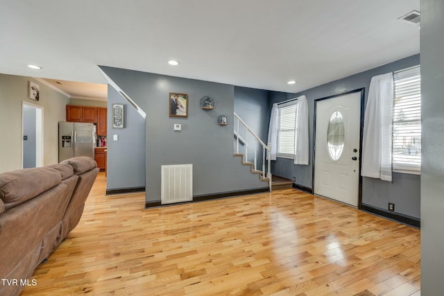 entrance foyer featuring light wood-type flooring and ornamental molding