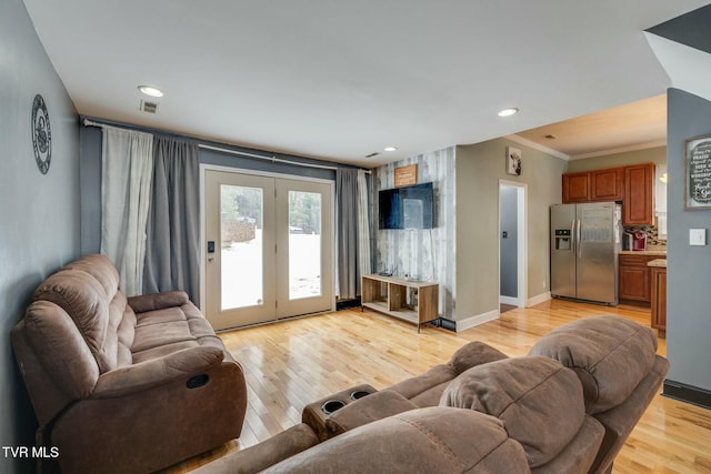 living room featuring light wood-type flooring and ornamental molding