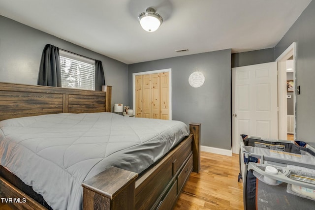 bedroom featuring light hardwood / wood-style floors and a closet