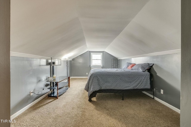 carpeted bedroom with lofted ceiling