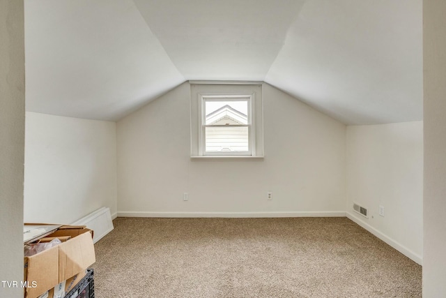 bonus room with carpet and vaulted ceiling