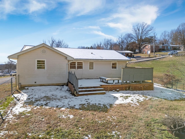 rear view of house with a yard and a wooden deck