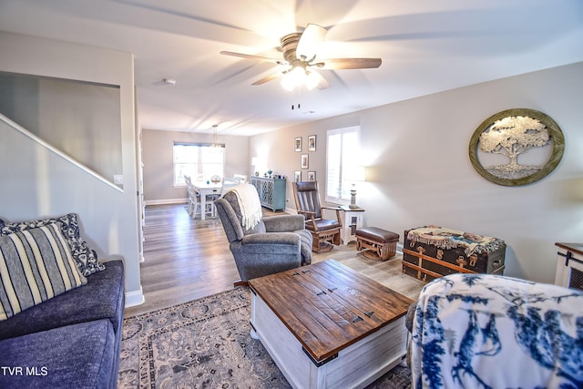 living room with ceiling fan, a healthy amount of sunlight, and wood-type flooring