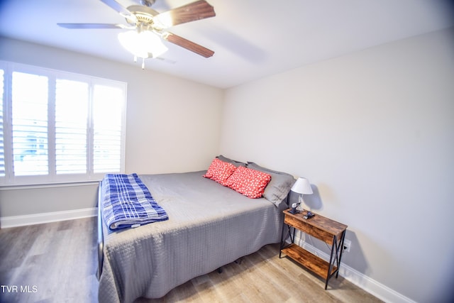 bedroom with ceiling fan and light hardwood / wood-style flooring