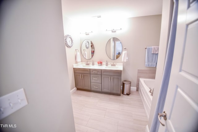 bathroom featuring vanity, a bathtub, and tile patterned floors