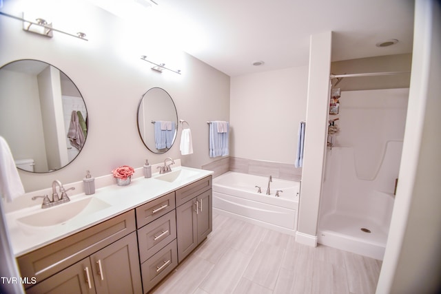 full bathroom with separate shower and tub, vanity, and toilet