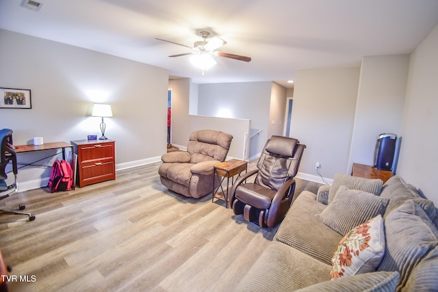 living room featuring light hardwood / wood-style floors and ceiling fan