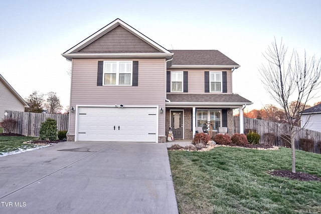 front of property with a porch, a yard, and a garage