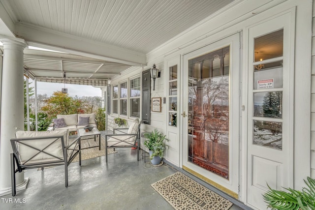 sunroom featuring beamed ceiling and ornate columns