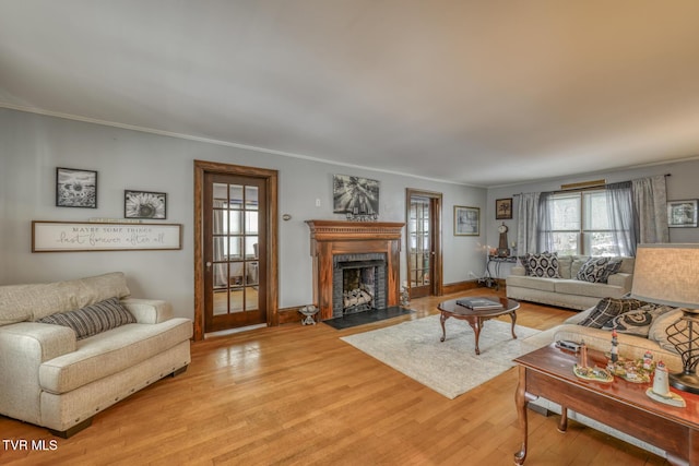 living room featuring crown molding and light wood-type flooring