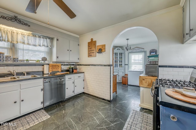 kitchen with ceiling fan with notable chandelier, crown molding, sink, appliances with stainless steel finishes, and white cabinetry