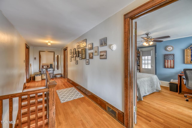 corridor with light hardwood / wood-style flooring