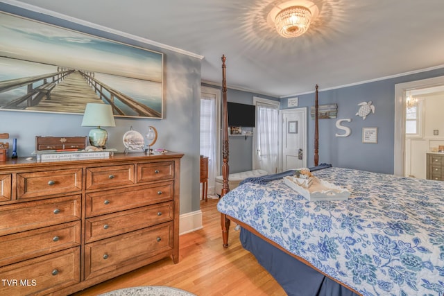 bedroom featuring ornamental molding and light wood-type flooring