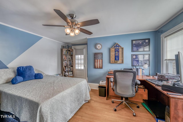 bedroom featuring ceiling fan, light hardwood / wood-style floors, and ornamental molding