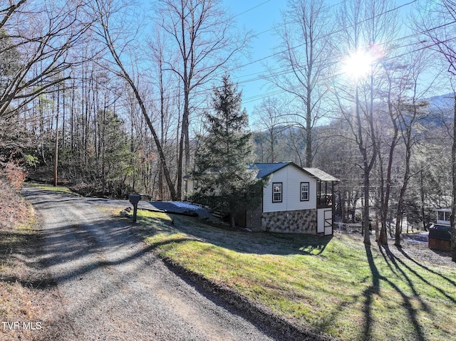 view of property exterior featuring a lawn