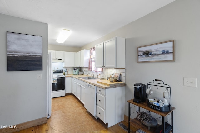 kitchen featuring dishwasher, white cabinetry, decorative backsplash, sink, and electric range