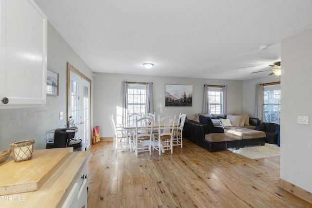 dining space featuring ceiling fan, a wealth of natural light, and light hardwood / wood-style flooring